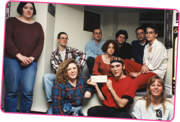 A group of volunteers from YouthLine, one of them holding a certificate possibly celebrating